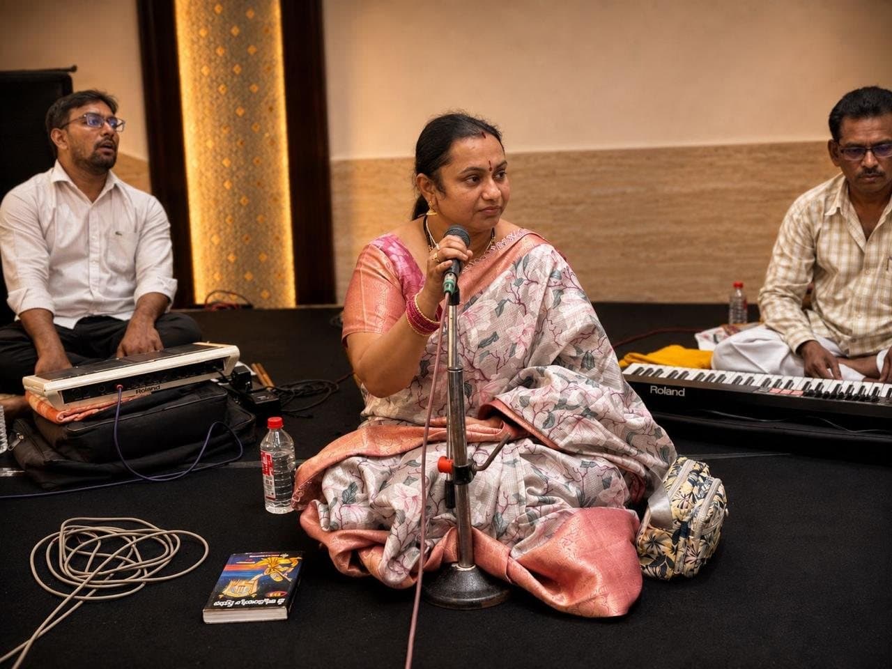 The guru with students at the harmonium